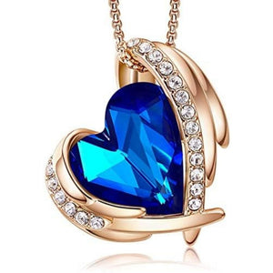 One woman showing the heart necklace to another