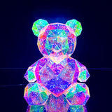 closeup of the cyber galaxy bear with led heart on dark background